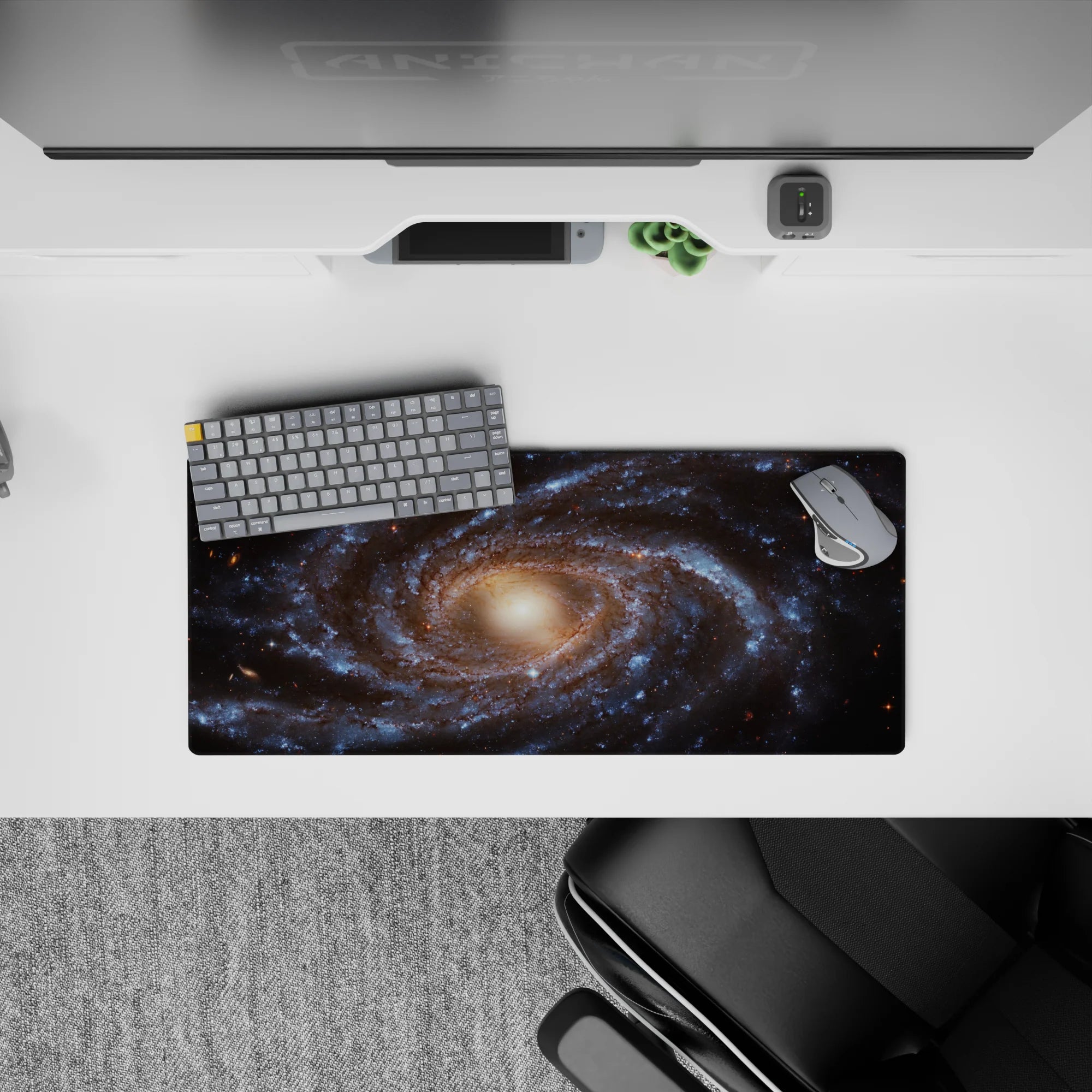 Large 28x12 inch mouse pad featuring a detailed spiral galaxy design with blue and golden cosmic tones.