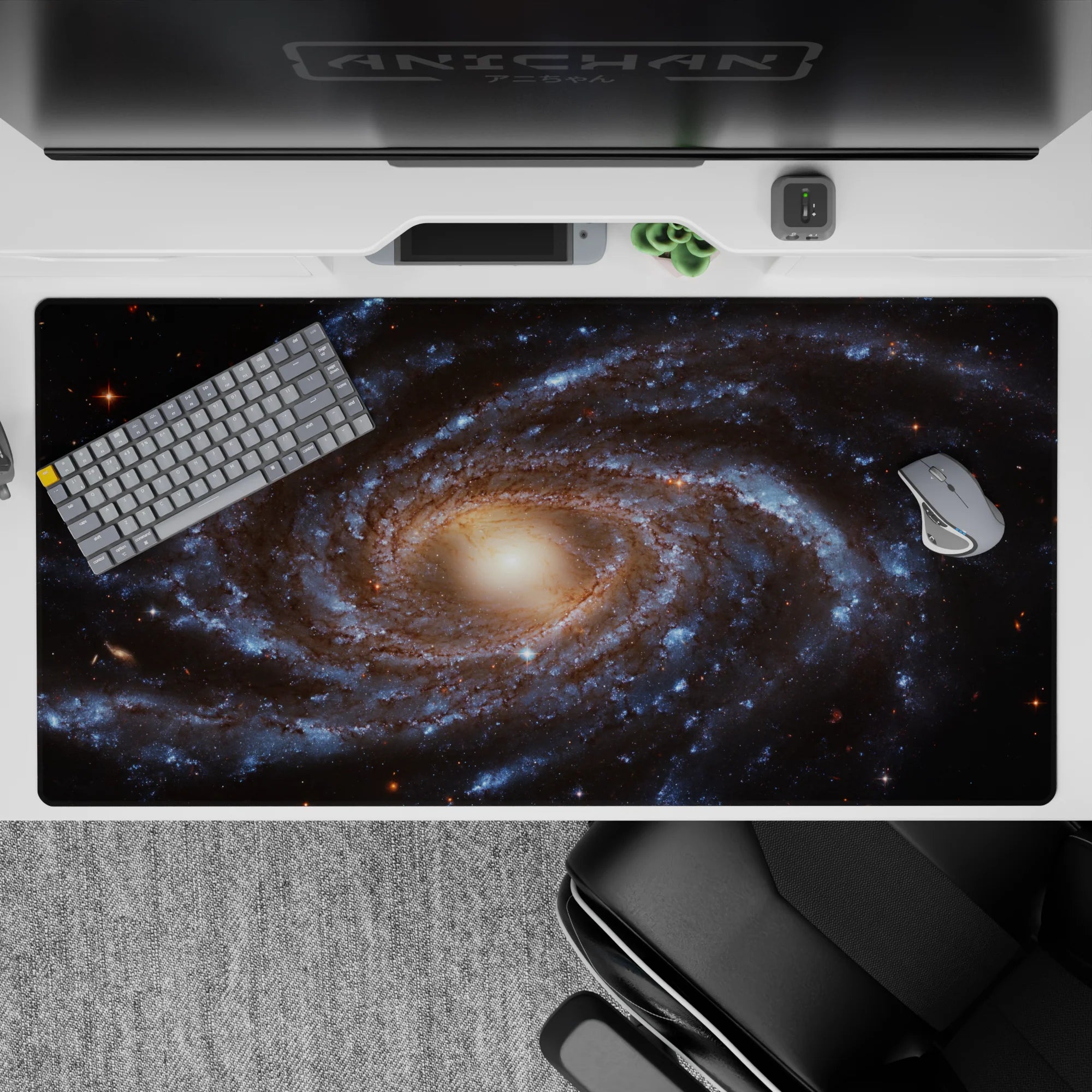 Desk pad with spiral galaxy print in smoky blues and gold, 40x20 inches, adds cosmic style to any workspace.