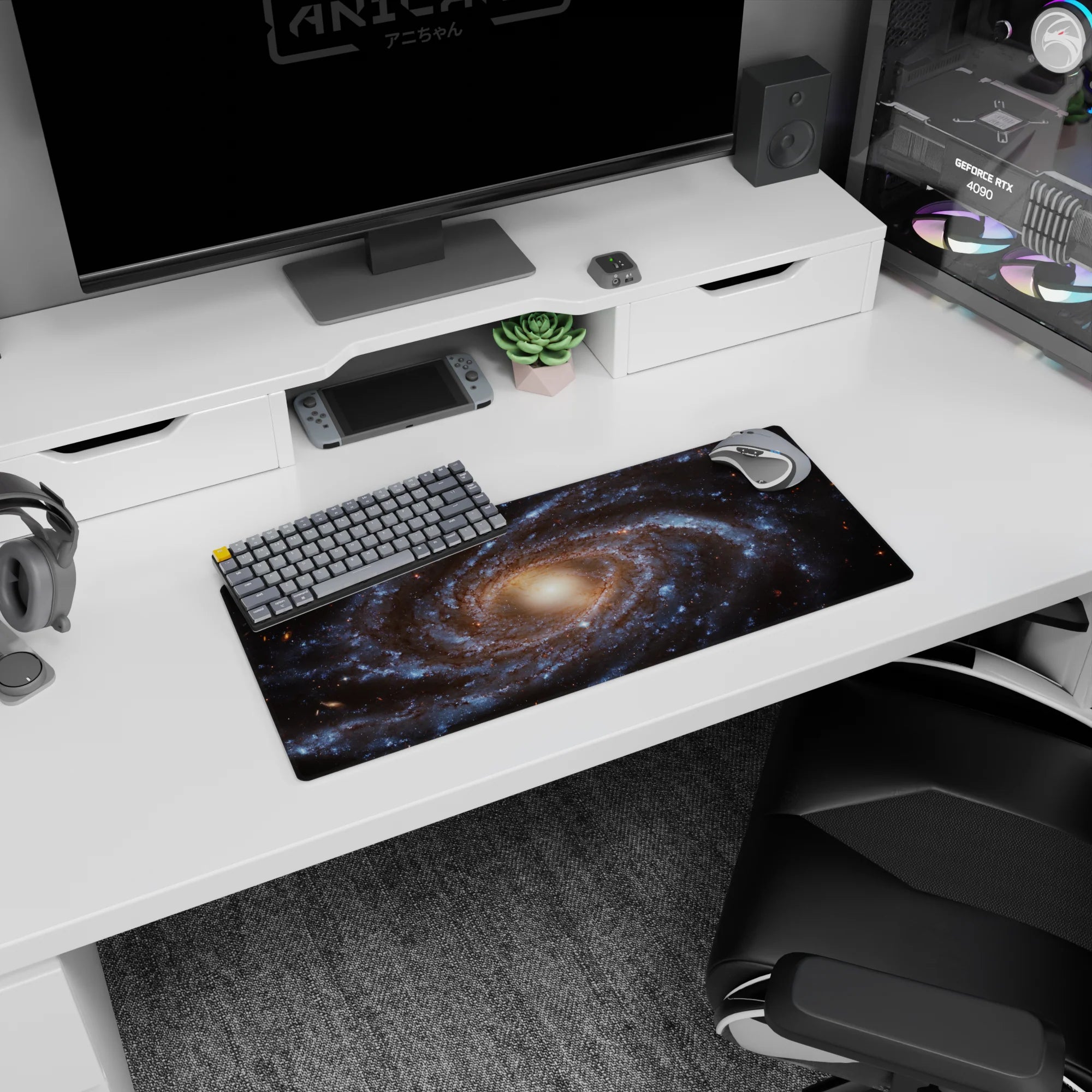 Large 28x12 inch mouse pad featuring a spiral galaxy design with swirling blues, gold tones, and stardust accents.