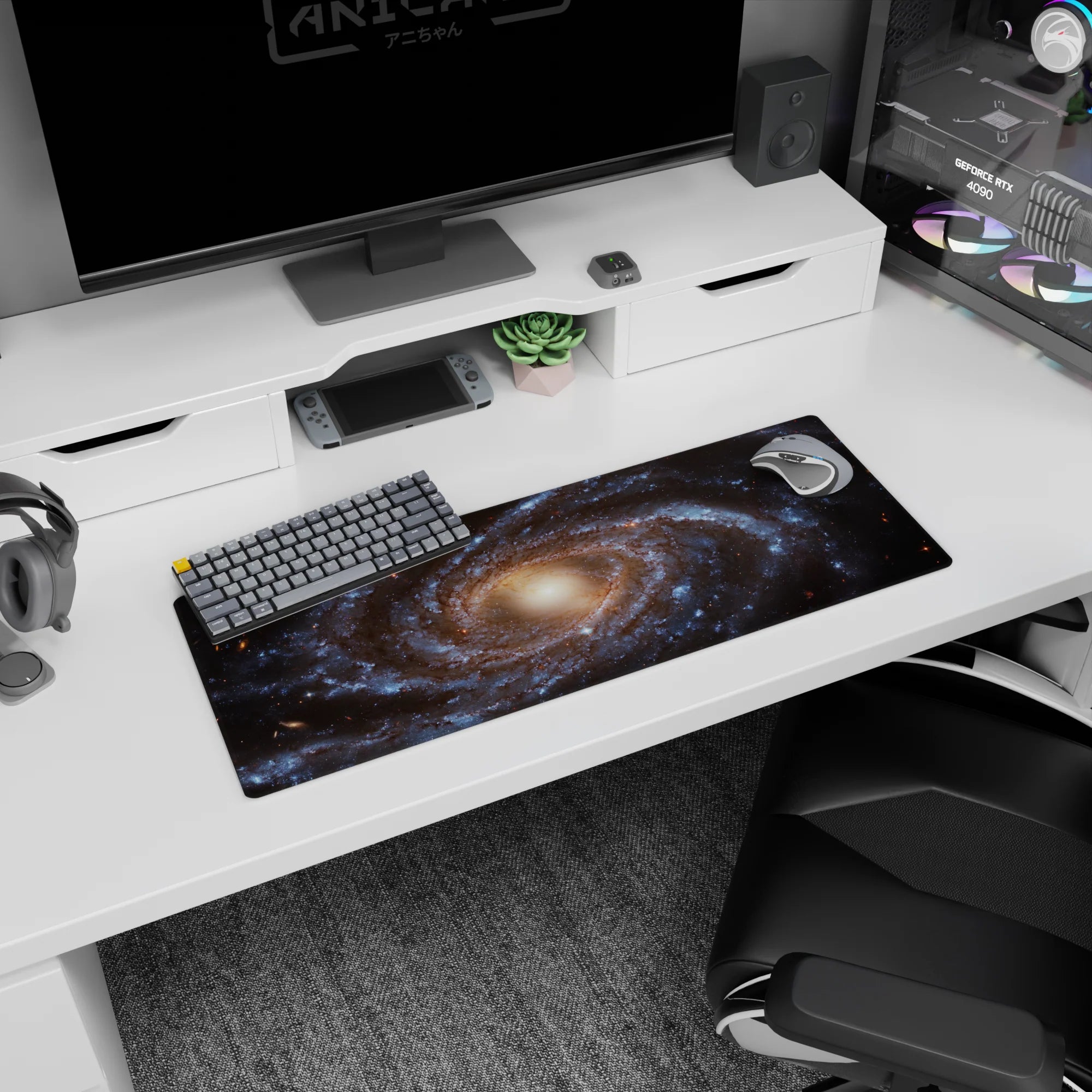 Large 32x12 inch mouse pad featuring a spiral galaxy design with blue tones, golden core, and cosmic details.