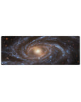 Large 32x12 inch mouse pad featuring a dreamy spiral galaxy design with swirling blues, gold tones, and stardust details.