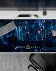 Neon rain, deep teal shadows, and pink-blue billboards on a cyberpunk anime desk pad 40x20 inches.