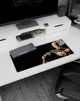 Saitama sitting in calm silence with hand on shoulder anime mouse pad 28x12 inches, focused gaze.