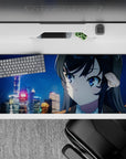 36x16 inches anime desk pad in neon blues and soft golds, cozy winter-night drama vibe with drifting snow.