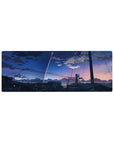 32x12 inches anime mouse pad with city rooftops, power lines, and a rocket trail across dusk sky.