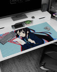 40x20 inches K-ON! Azusa Nakano desk pad, blushing with paper and pencil in a cram-session pose.