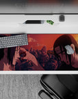 36x16 inches anime desk pad in sunset reds and burnt orange, quiet tragic vibe with glowing embers.