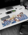 Anime girls in navy blazers and red ties crowd together on desk pad 36x16 inches, shy smile and wink.