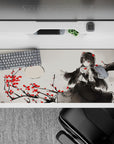 Moody ink-wash gray anime desk pad 36x16 inches with crimson blossoms and sharp red-eyed gothic vibe.