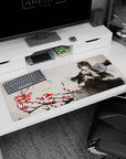 Raven-haired anime heroine in frilly black beside rose-strewn branches desk pad 36x16 inches.