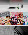 Pastel yellow-pink-blue anime girl desk pad 36x16 inches, bright loud playful stage vibe.