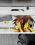 Warm gold glow anime desk pad 36x16 inches, calm focus vibe on white background with drifting spirits.