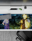 36x16 inches anime desk pad in steel-blue shadows and Kurama gold glow, gritty rocky texture.
