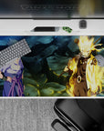 40x20 inches anime desk pad in steel-blue shadows with Kurama gold glow, warm light on dark backdrop.