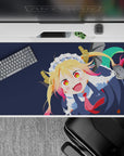 40x20 inches desk pad in deep navy with blonde hair and pink tips, playful chaos grin, red tie pop.