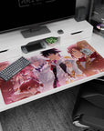 40x20 inches anime desk pad showing a grinning chaotic girl beside a cool silver-haired teammate at sunset.