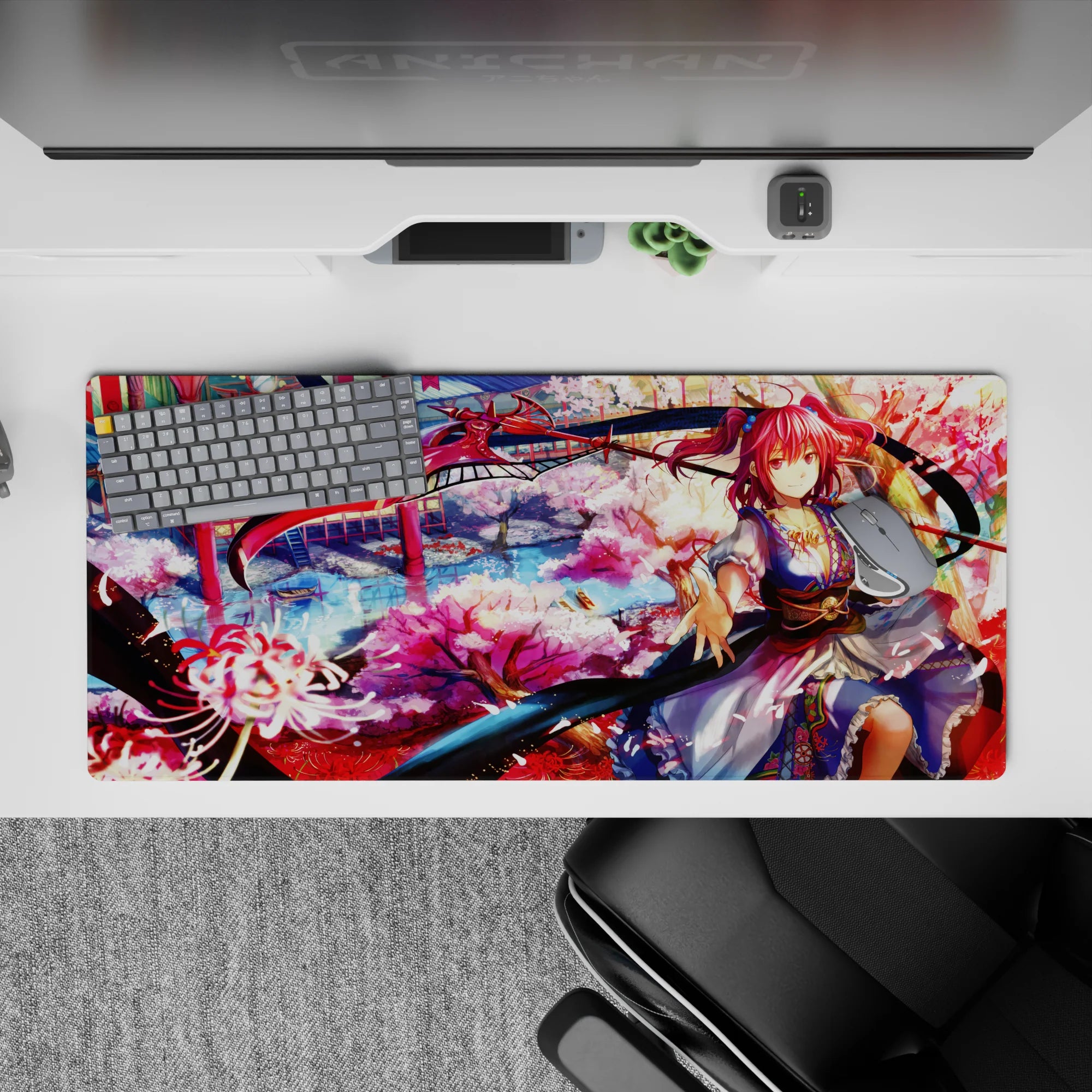 Dreamy 36x16 inches anime desk pad in sakura pink, lantern red, and cool river blue with drifting petals.