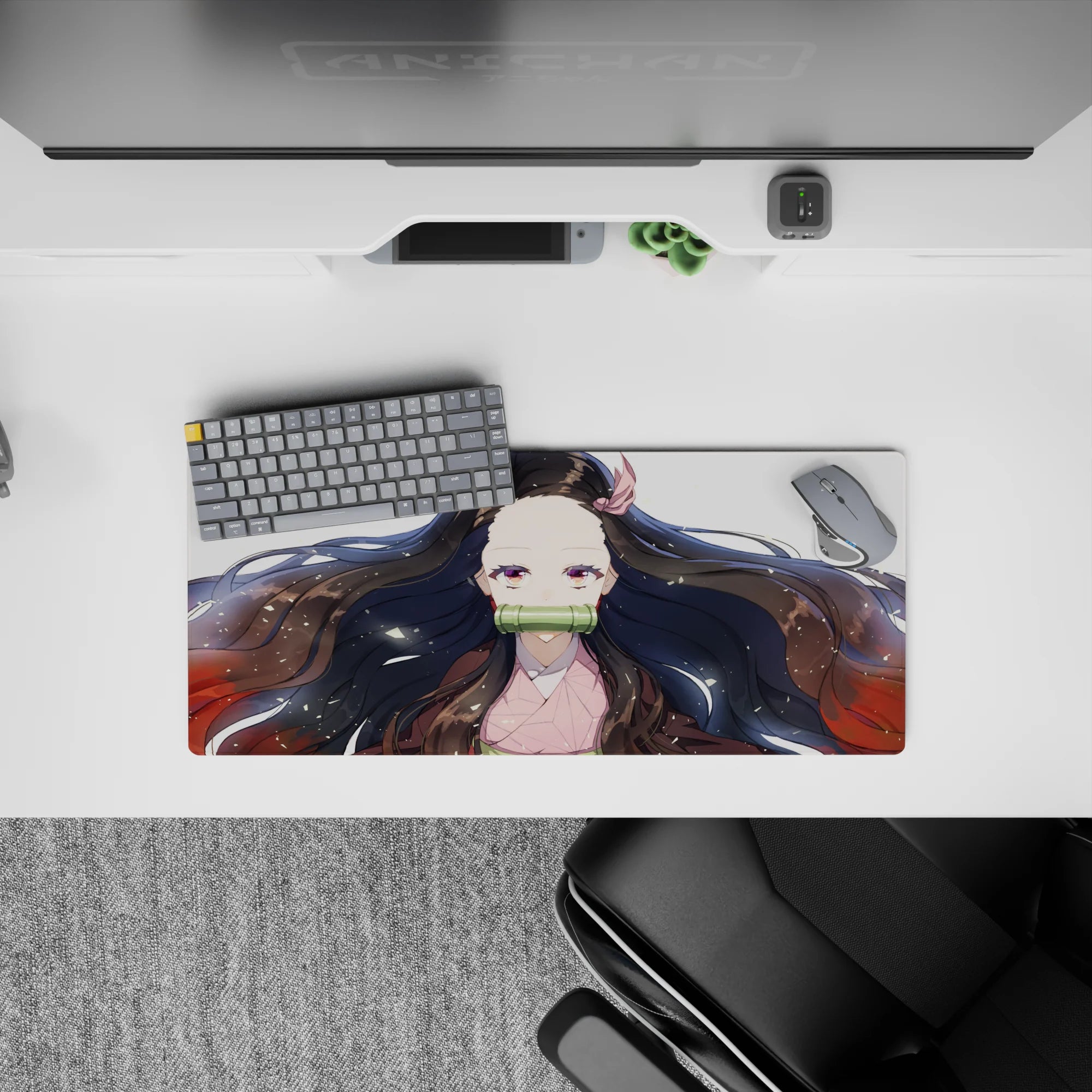 Nezuko anime mouse pad, 28x12 inches, features her serene gaze, flowing black hair with red tips, and gold flecks on white.