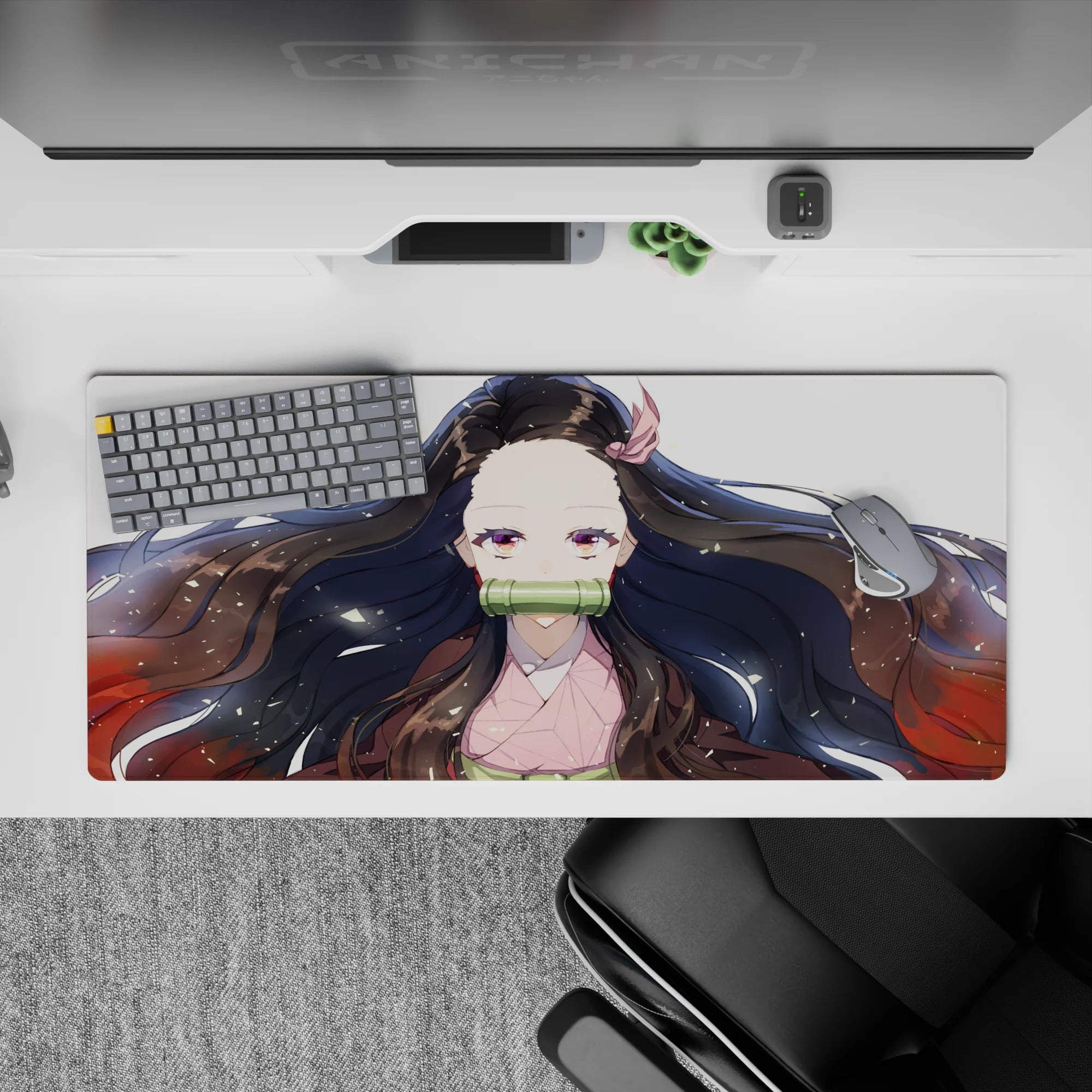 Nezuko anime mouse pad, 36x16 inches, featuring Nezuko's serene gaze, black hair with red tips, and gold flecks on white.