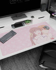 40x20 inches anime desk pad showing girl hugging boy from behind, ribbon and bracelet, laughing eyes closed.