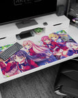 Large anime desk mat 40x20 inches featuring two schoolgirls in red blazers, smiling in spring leaves.