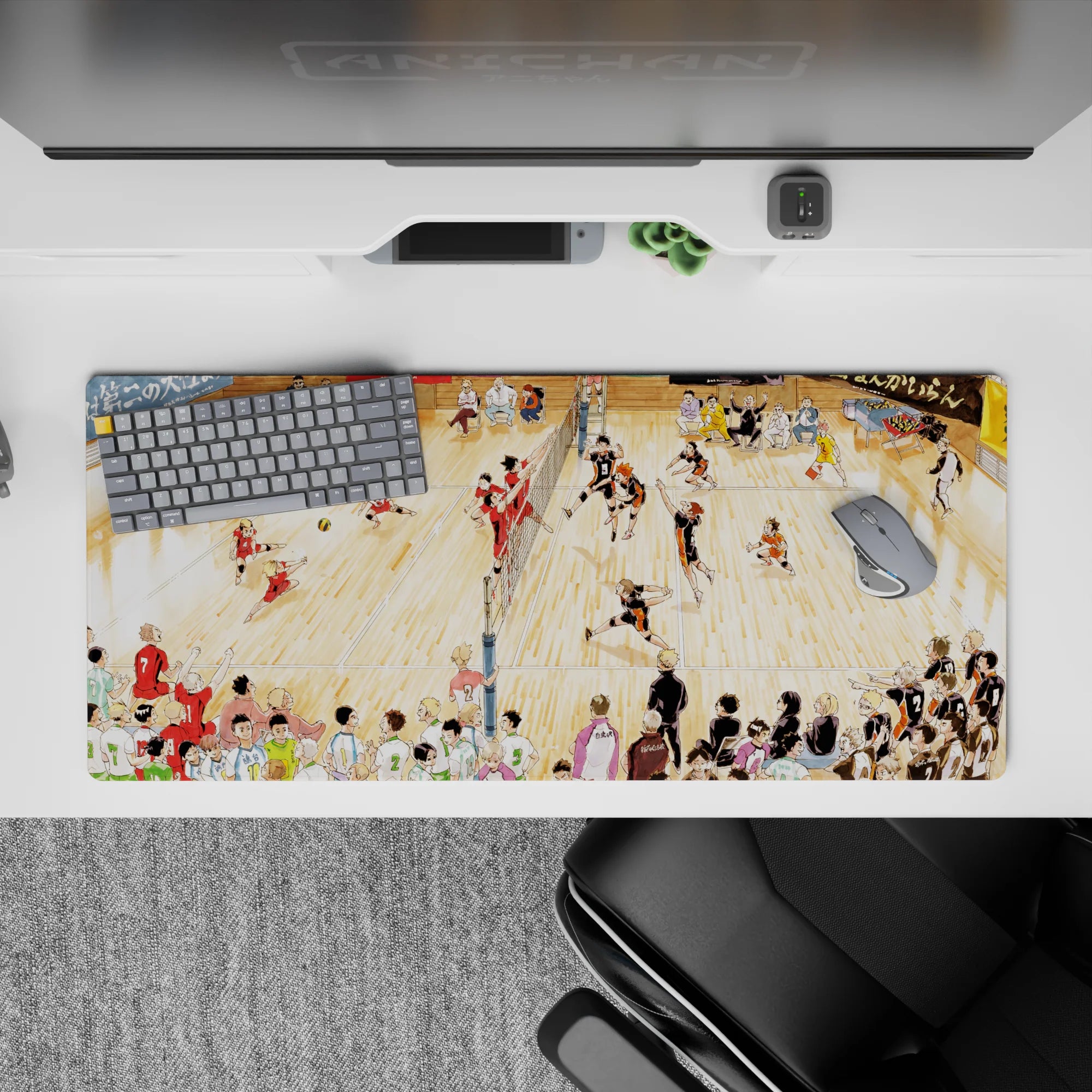 36x16 inches anime desk pad in warm gym light, black-orange vs red jerseys, loud tournament vibe, smooth glide.