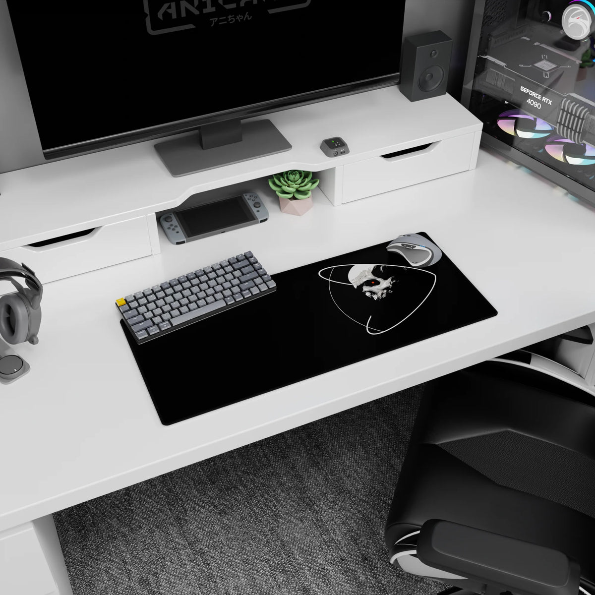 Floating skull in space with looping orbit rings and a red eye on a mouse pad, 28x12 inches.