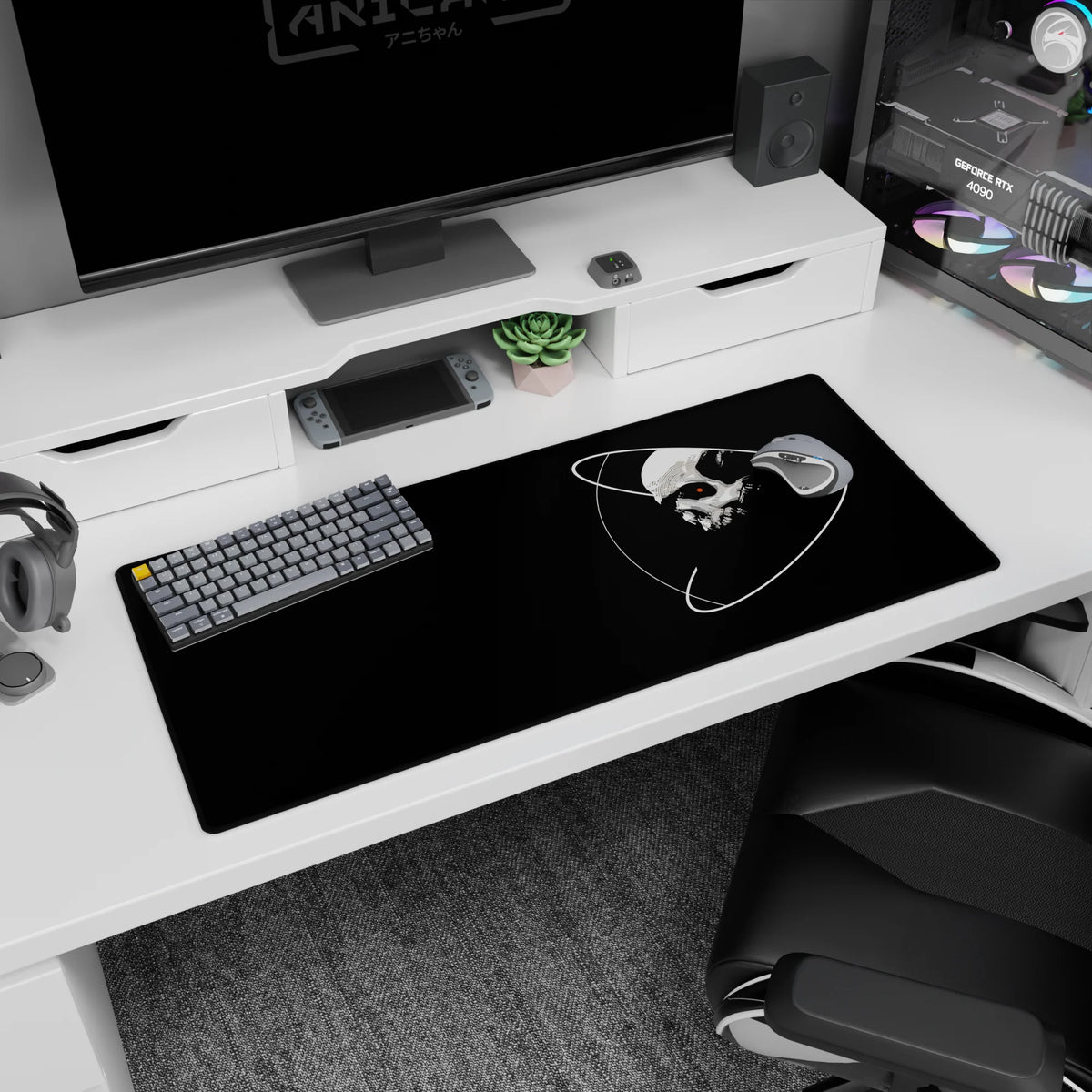 Stark skull with a tiny red eye floating in orbit rings on a 36x16 inches extended desk pad.