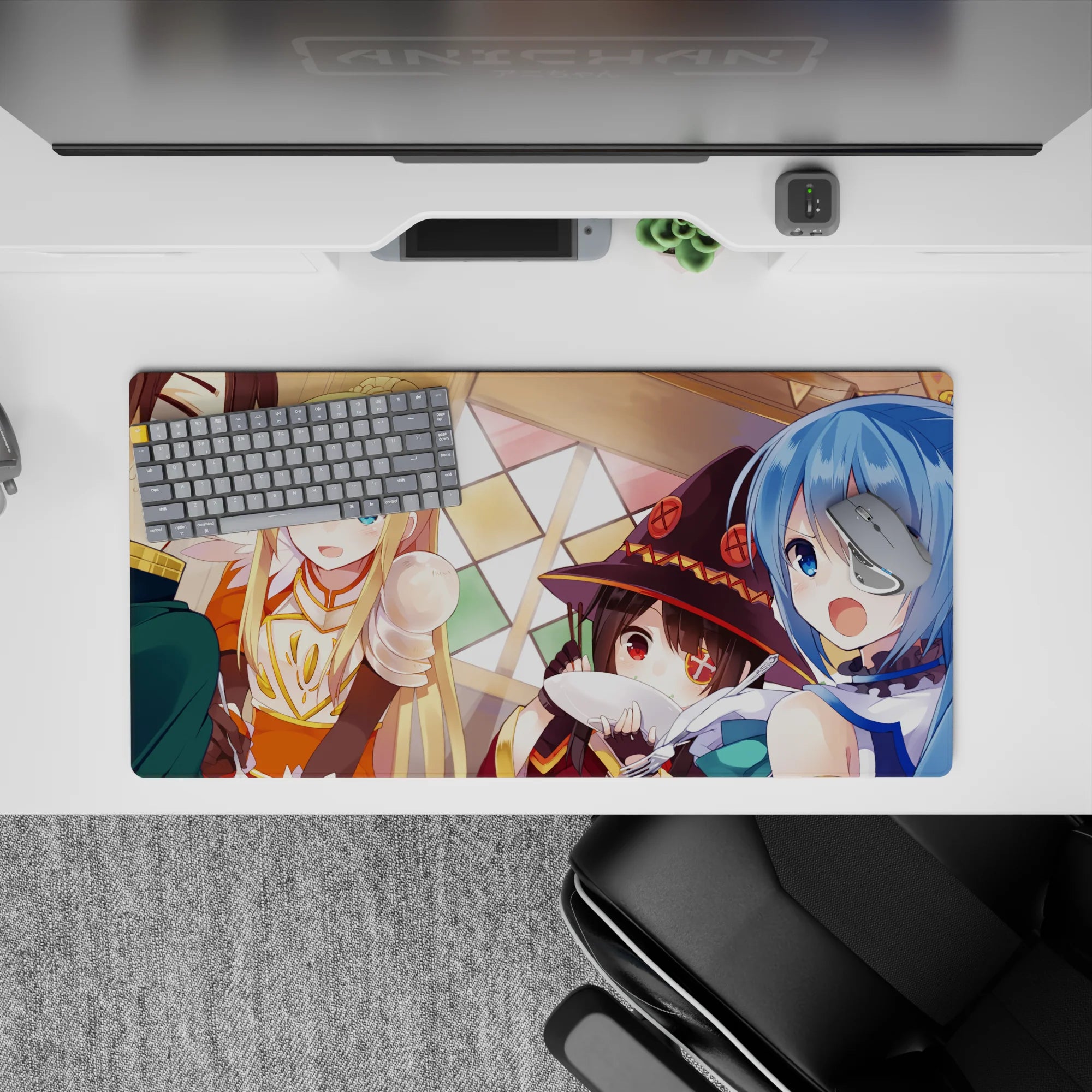 Anime mouse pad featuring a 32x16 inch scene from KonoSuba with Kazuma, Aqua, Darkness, and Megumin at a chaotic dinner.