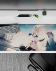 Pastel peach clouds and cool gray gothic skyline on an anime desk pad 36x16 inches, dreamy calm vibe.