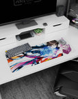 Anime girl mouse pad 32x12 inches showing sharp-eyed boy holding pink-haired girl mid-fall with swirling blue ribbons.