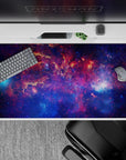 Dreamy late-night sky desk pad in deep violet, midnight blue, and nebula pink, 40x20 inches.
