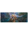 Cosmic nebula desk mouse pad 32x12 inches with teal clouds, inky blue swirls, and star sparks.