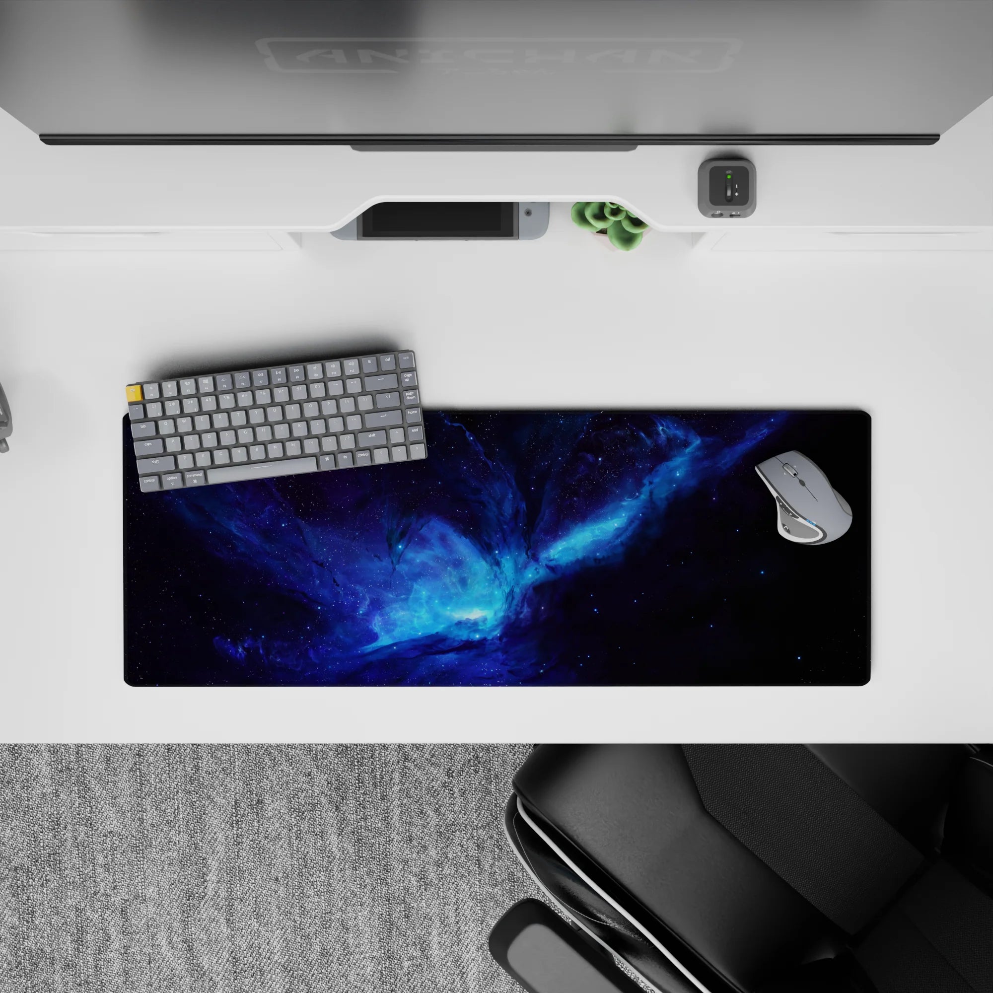 Moody space mouse pad 32x12 inches in inky blacks with electric blues and smoky purples.