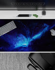 Electric blues and smoky purples galaxy desk pad, calm-to-wild space vibe, 40x20 inches.