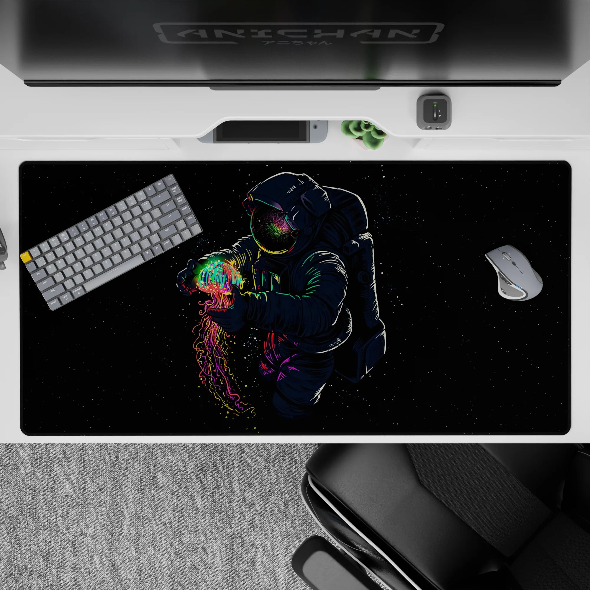 Dreamy sci-fi desk pad in midnight black with neon rainbow accents, 40x20 inches.