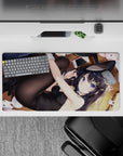 Cozy flirty violet-toned anime desk mat 32x16 inches, warm wood floor glow and bold color.