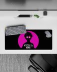 Bold neon pink and black anime mouse pad 28x12 inches with electric white eyes, city sunset vibe.