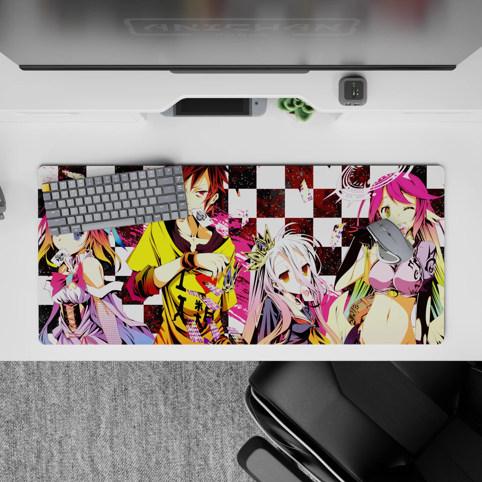 Chaotic cute pink splashes on black-and-white checkers, loud gaming desk pad 36x16 inches.