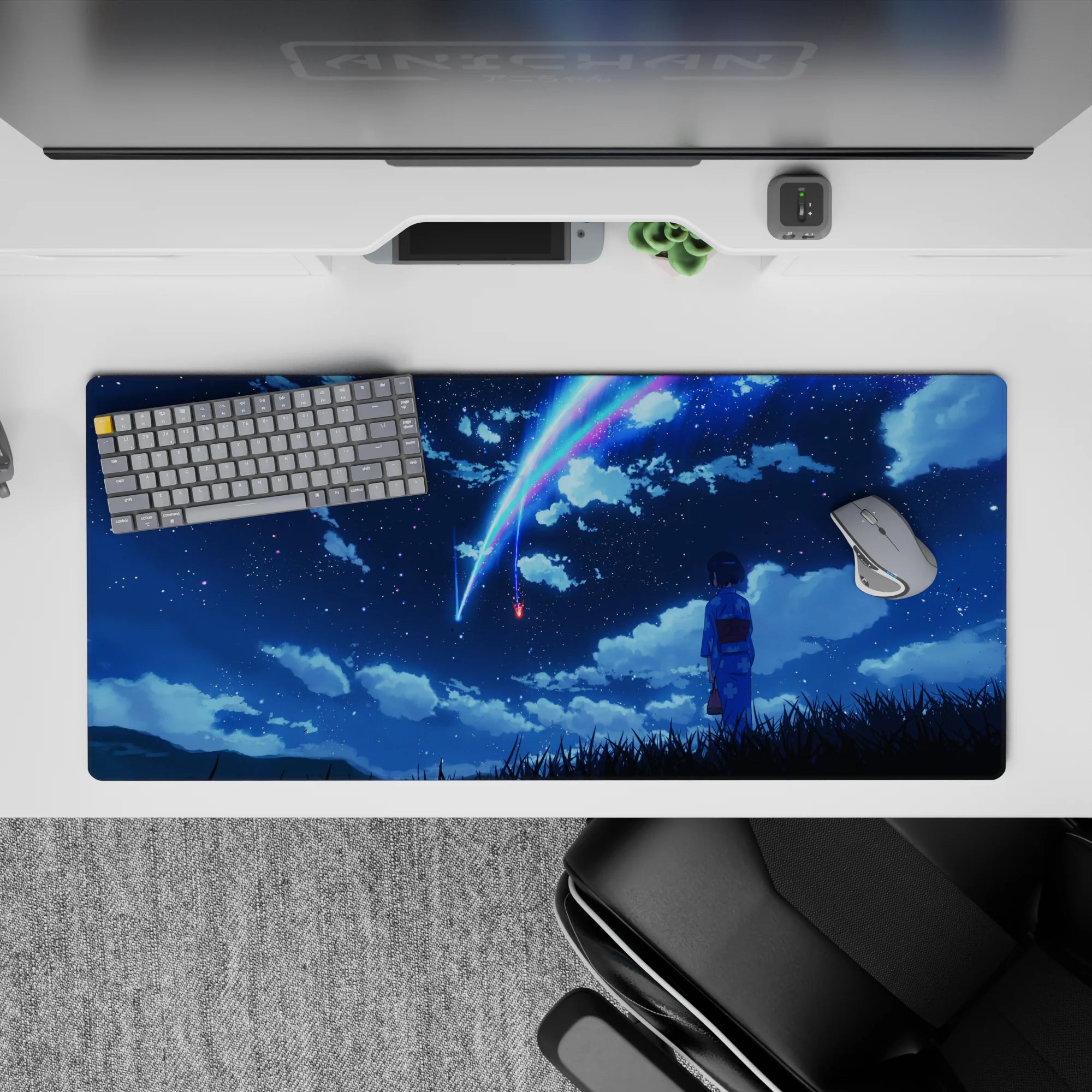 36x16 inches anime desk pad in deep navy with neon blue-pink comet streaks, calm dreamy night sky.
