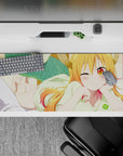 36x16 inches desk pad with warm orange-to-pink hair, golden eyes, cozy playful anime vibe.
