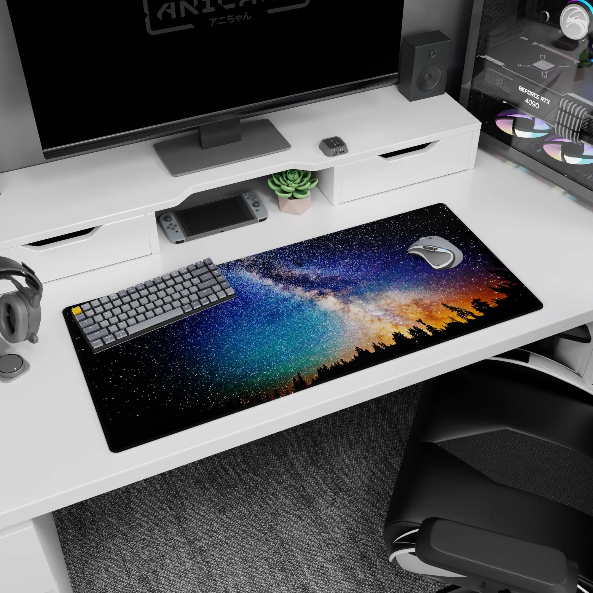 Star-filled night sky desk pad with pine silhouettes and warm amber glow on the horizon, 36x16 inches.