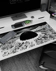 Anime desk pad 40x20 inches showing a black sun over ruined towers and rubble spiraling into a sky vortex.