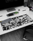 36x16 inches anime desk pad showing a schoolgirl selfie as others lean in like a secret club crowd.