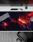 Navy-to-ember desk pad 40x20 inches with glowing orange clouds and cozy dramatic space mood.