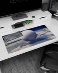 Giant moon-like white orb floating in a quiet blue sky mouse pad 32x16 inches with tiny star specks.