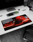 32x16 inches Alucard anime desk mat, coat flaring, gloved hand on chest, aiming a long pistol at you.