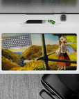 Cozy anime girl mouse pad 32x16 inches in warm golds and leafy greens with soft sky gradients.