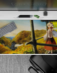 Cozy adventure anime desk pad 40x20 inches in warm golds, leafy greens, and soft sky gradients.
