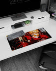 28x12 inches anime mouse pad showing spiky blond shooter in orange shades aiming a pistol at you.